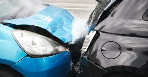 Close Up Of Two Cars Damaged In Road Traffic Accident
